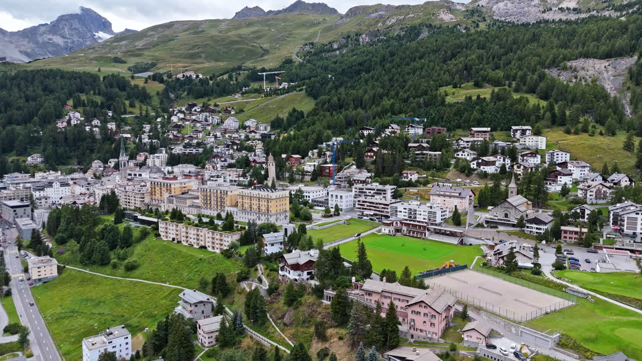 Aerial view of Saint Moritz village with lush mountains and rich nature