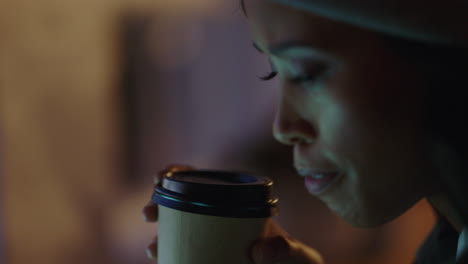 close-up-young-african-american-business-woman-using-smartphone-browsing-online-reading-social-media-messages-texting-drinking-coffee-working-late-at-night