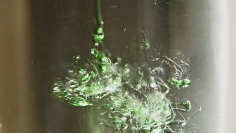 liquid dish soap falling in water in slow motion