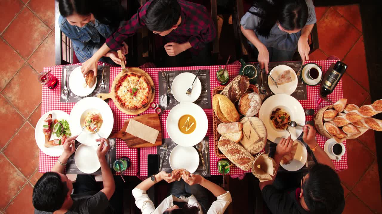 Group Of Friends Enjoying Meal In Restaurant, Video 4K