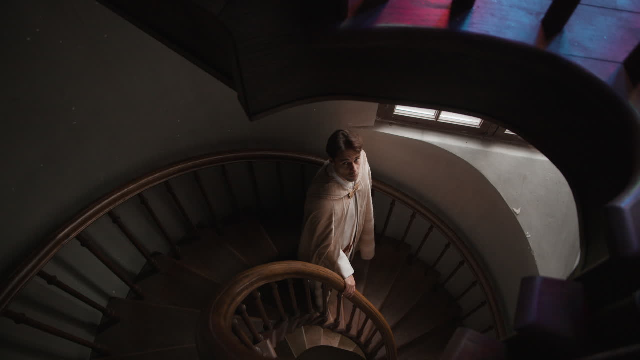 A man standing on a spiral staircase