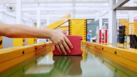 Kids-grab-toy-bricks-from-a-conveyor-belt-at-science-centre