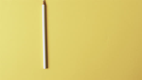 close up of yellow pencil with copy space on yellow background