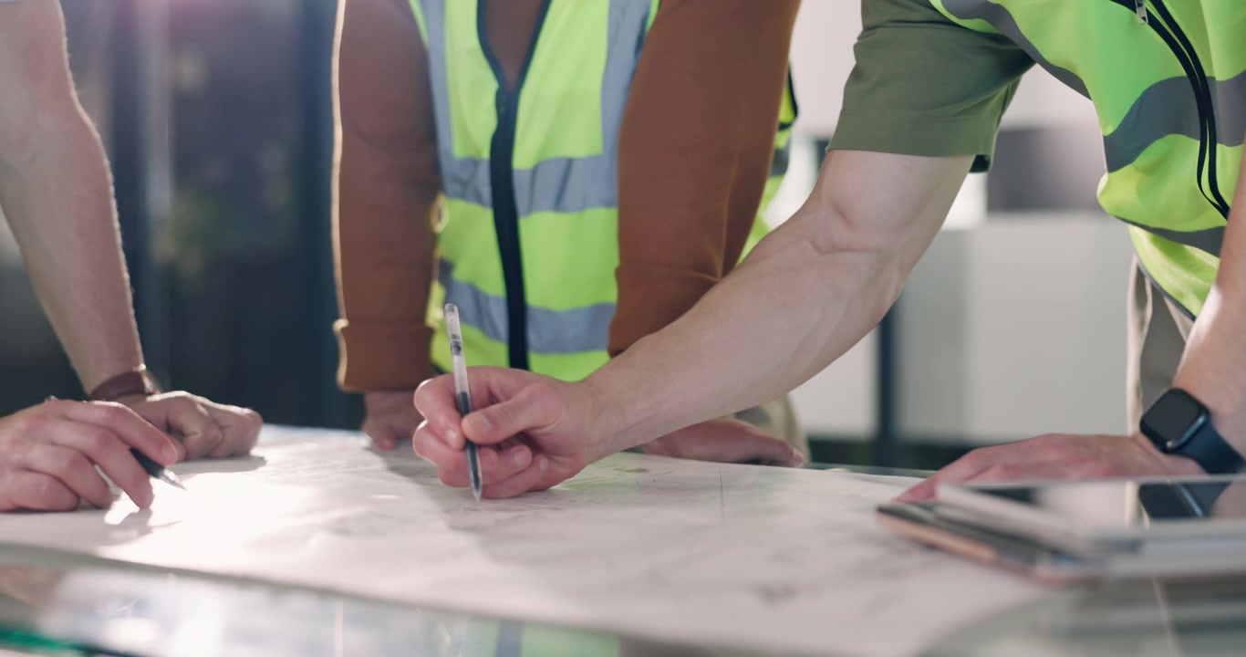 Engineers and Architects Reviewing Construction Blueprints in Office