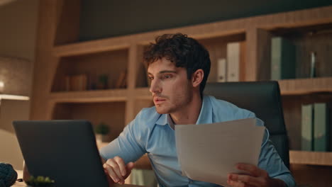 happy businessman examining papers celebrating great financial results in office