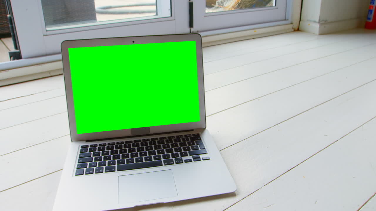 Close-up of laptop on wooden floor at home 4k