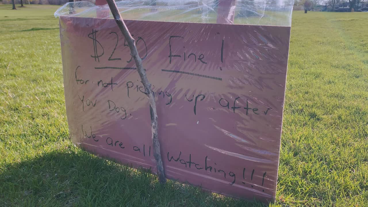 Sign reminding dog owners to pick up after their dogs