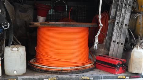 orange fiber optic cable spool in a work truck