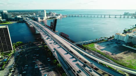 Massive-transportation-bridge-with-afternoon-traffic-mainly-one-side-out-of-the-city-stand-still-river-pool-water-various-vehicles-city-vibe-atmosphere-sunny-in-Acosta-Bridge,-Jacksonville,-Florida