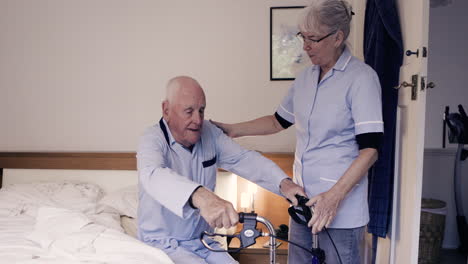 elderly man assisted by caregiver at home