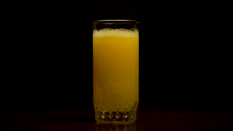 pouring orange soda into a glass