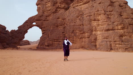 Male-Tourist-Near-Elephant-Rock-Monument-In-Tassili-N'Ajjer-National-Park,-Algeria---Pullback-Shot