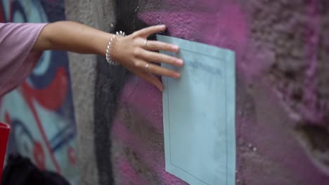 liquid glue being applied to a poster with a brush