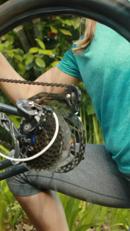 female cyclist repairing bicycle tyre