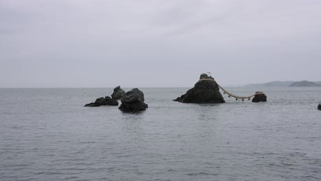 4k pan reveal of ise shrine and meoto iwa rocks on the coastline of japan