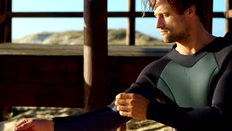 male surfer wearing wetsuit in the beach 4k