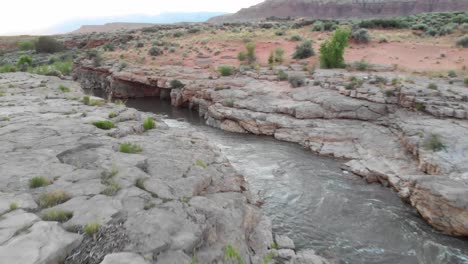 a scenic river running through red rock basin