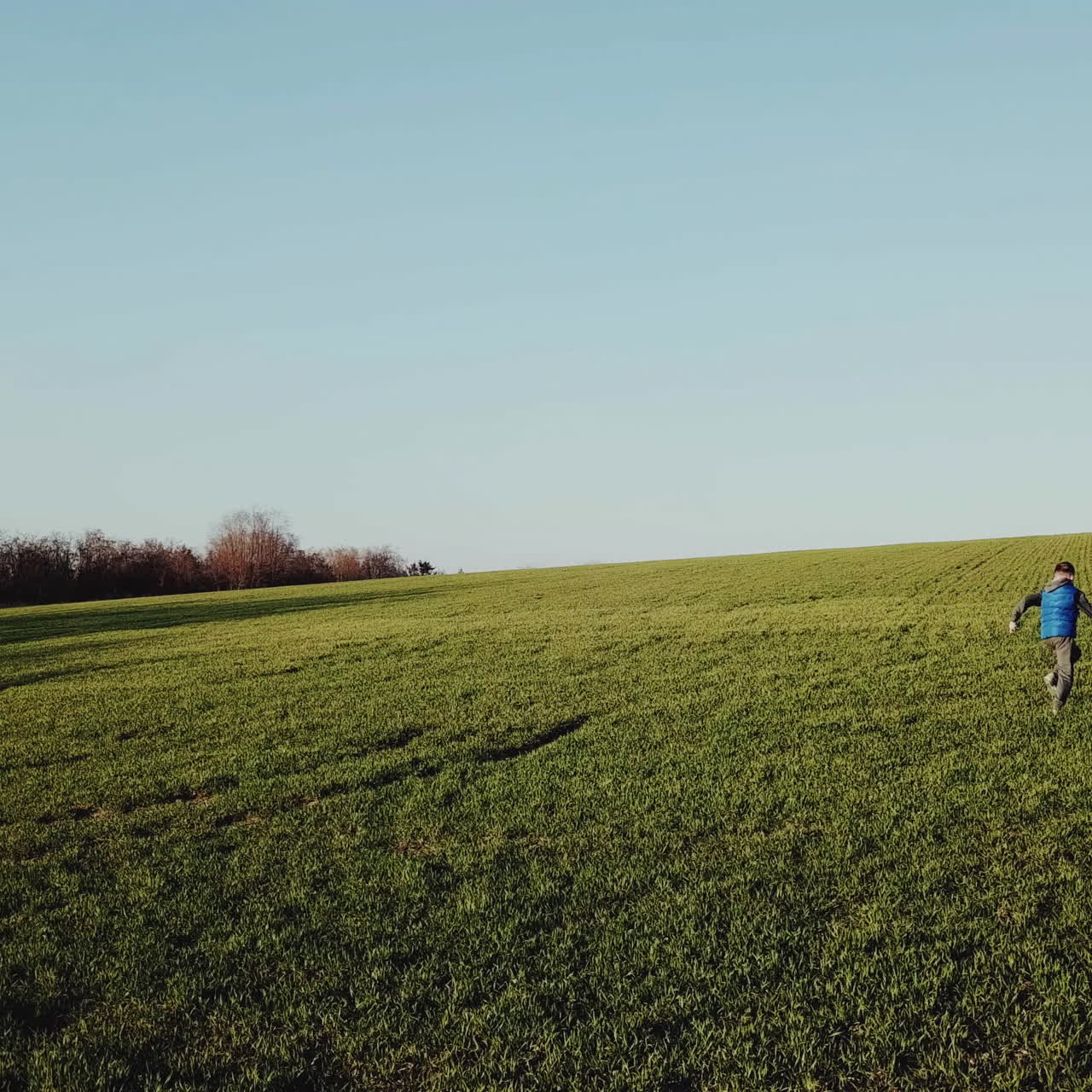 Two boys playing on the field. Aerial view Square video