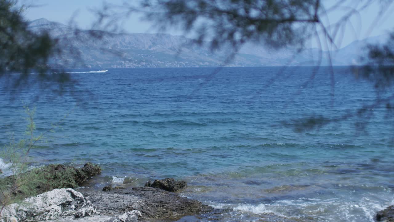 Seascape of small sea waves coming on the rocky beach