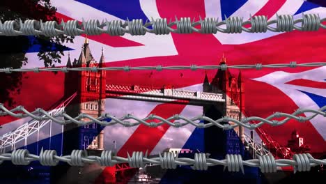 barbed wires against uk waving flag