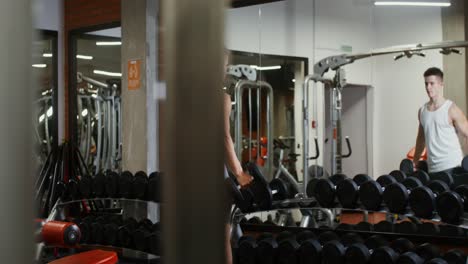 man working out with dumbbells in a gym