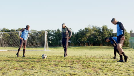 playing soccer on field, players and coach preparing for practice session