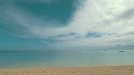 Shore-with-clear-blue-water-and-soft-sand