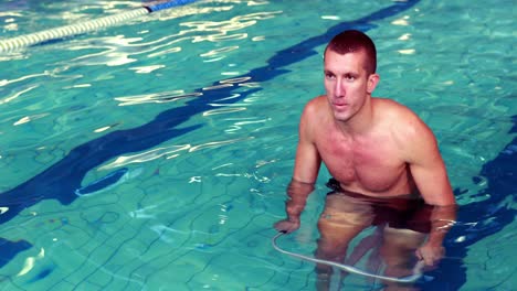 fit man cycling in the pool