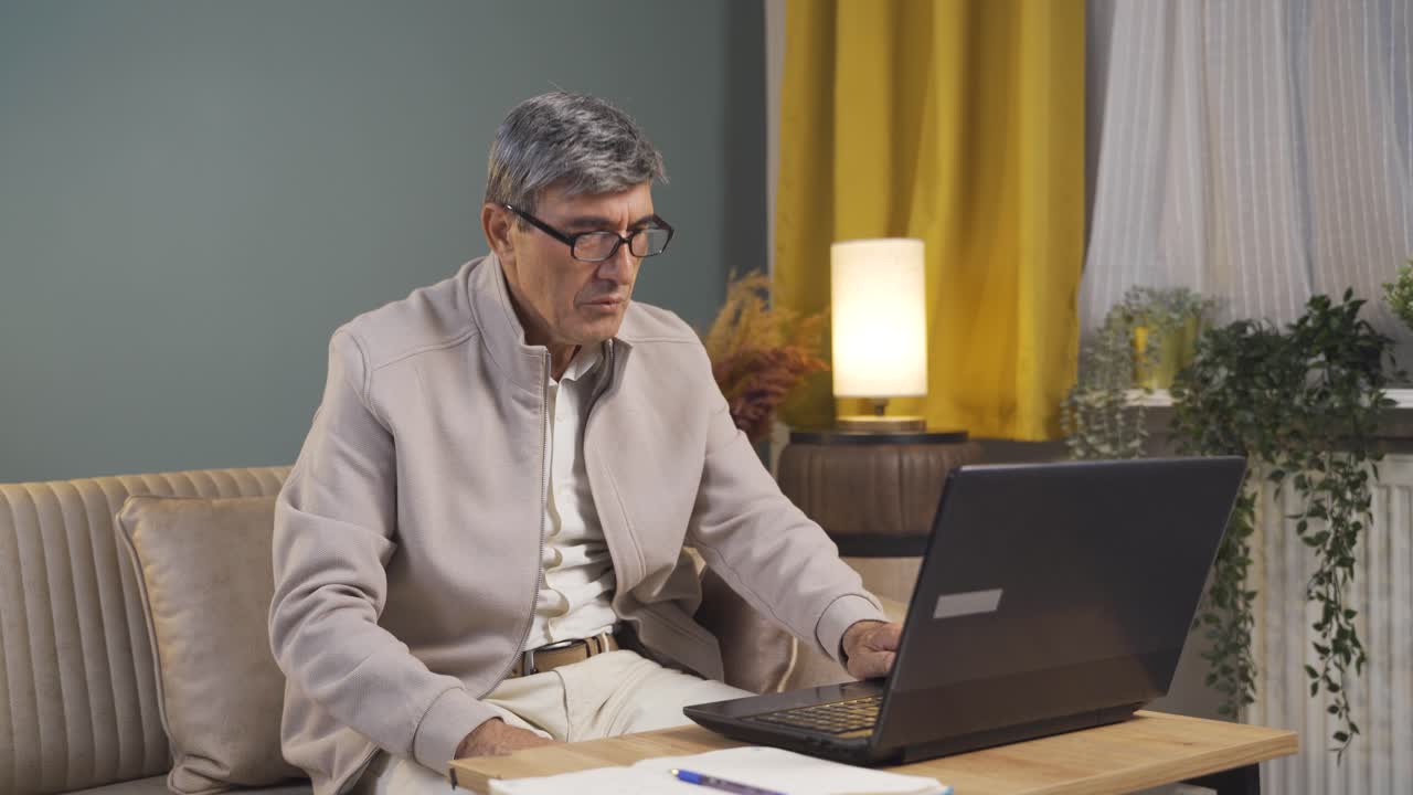 The old man who likes the application on the laptop is happy.