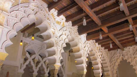 decorative arches in moorish-taifa north side hall inside aljaferia palace in zaragoza, aragon, spain