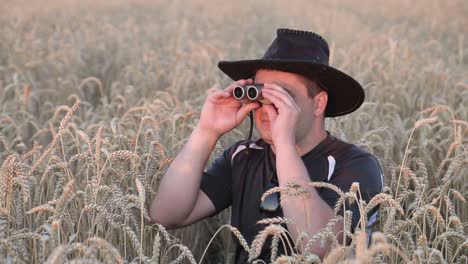 young traveler man holding binoculars on the mountains young traveler man holding binoculars in the field