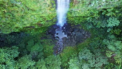 top shot of a towering epic waterfall falling into the jungle of the dominican republic in the salto del rodeo region of bonao