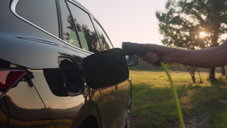 Hombre-Poniendo-Un-Cargador-En-Un-Automóvil-Y-Ajustando-Una-Aplicación-De-Carga-De-Vehículos-Eléctricos-En-El-Móvil