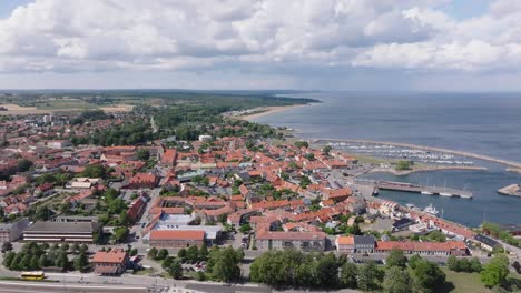 aerial sideways over small city simrishamn in sweden on a sunny cloudy day