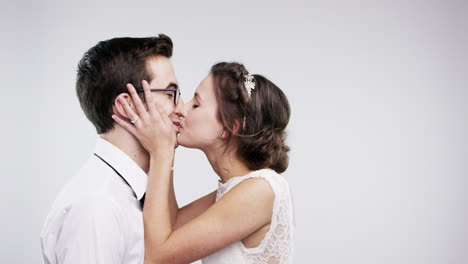 newlyweds kissing amidst confetti