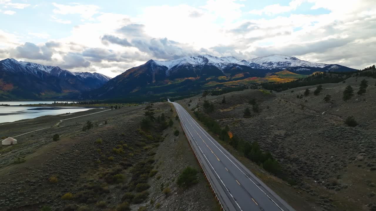 Scenic aerial footage of a winding mountain road disappearing into the distance in Independence Pass
