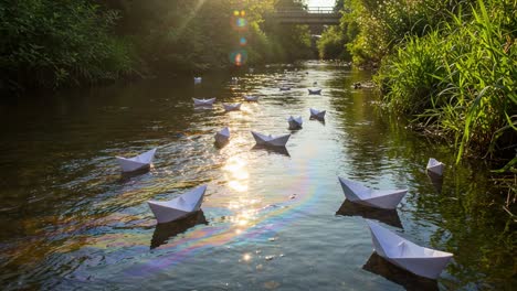 a serene collection of floating paper boats gliding along a sunlit stream surrounded by lush greenery, creating a peaceful outdoor atmosphere