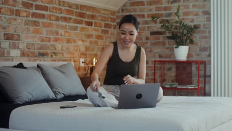 woman sharing ultrasound images on video call in her bedroom