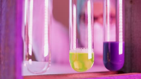 colorful liquid dripped into glass tubes by scientist on laboratory for finding new test on coronavirus infected patients