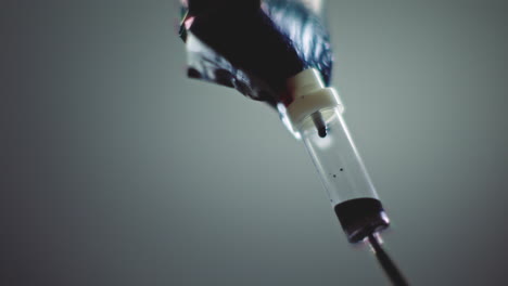 dark liquid is dripping slowly