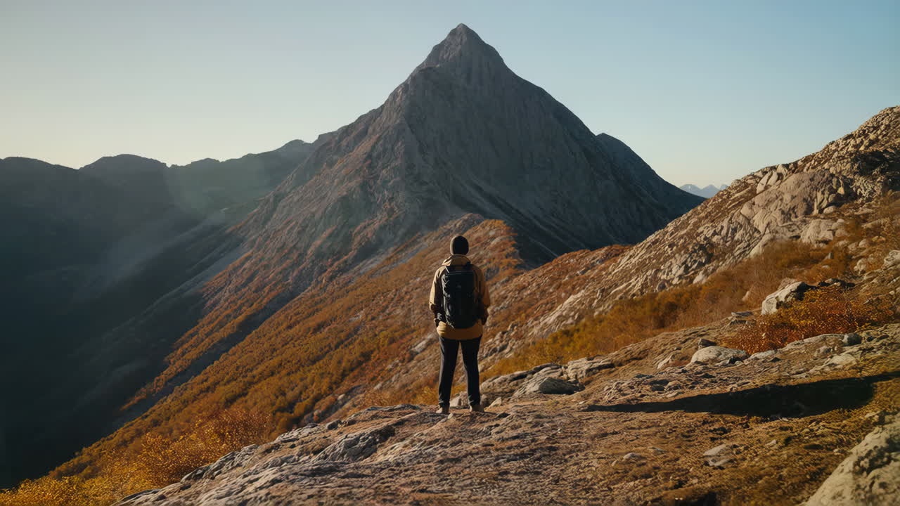 Hiker with backpack in mountain landscape