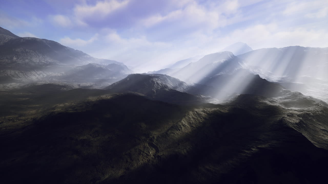 Majestic mountain landscape with sunlight illuminating valleys and peaks