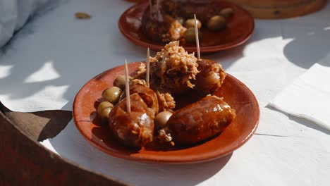 traditional alheira sausage plate with olives. portugal