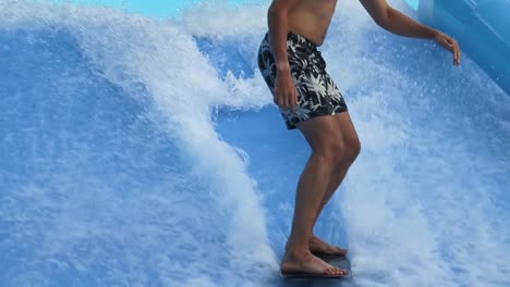 person surfing on an indoor wave