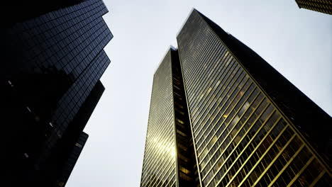 tall glass skyscrapers reflecting light in an urban skyline during twilight