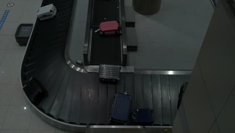 timelapse of luggage arriving to baggage claim area