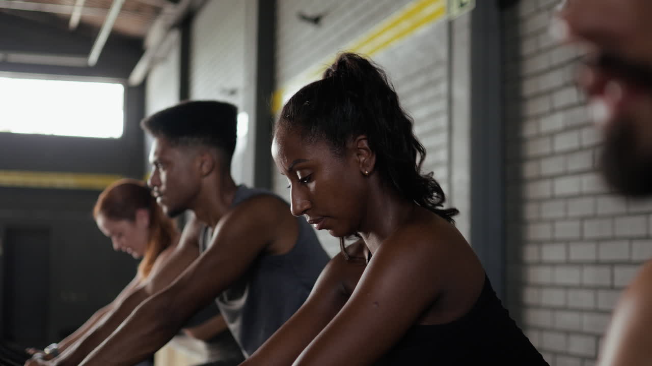People Working Out on Exercise Bikes in Gym