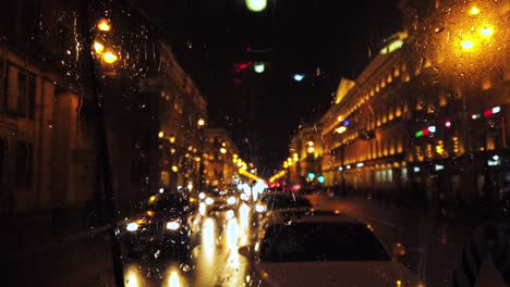 defocused lights in night city street while it's rainnnig