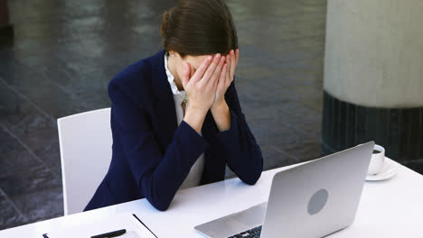 businesswoman working on laptop at desk 4k