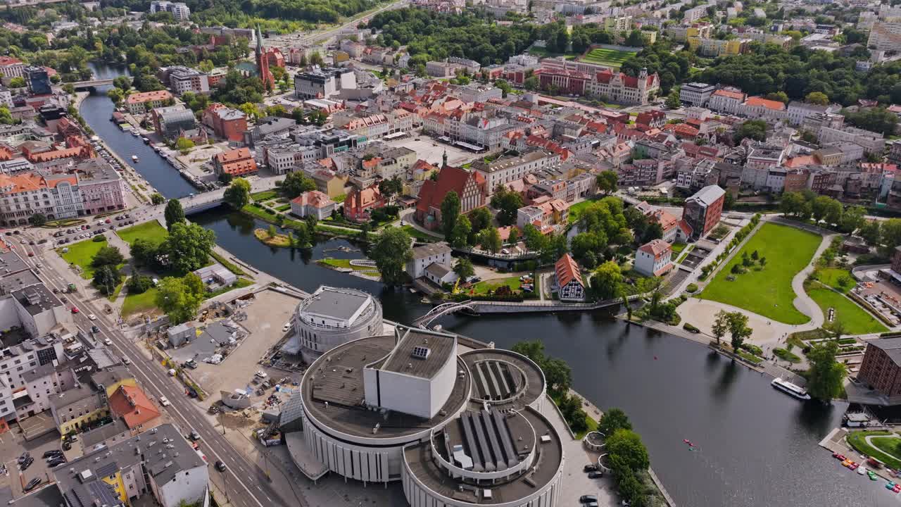Drone establishing view of Bydgoszcz Poland city center with Opera Nova, river